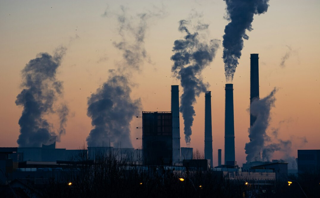 Industrial smokestacks releasing emissions